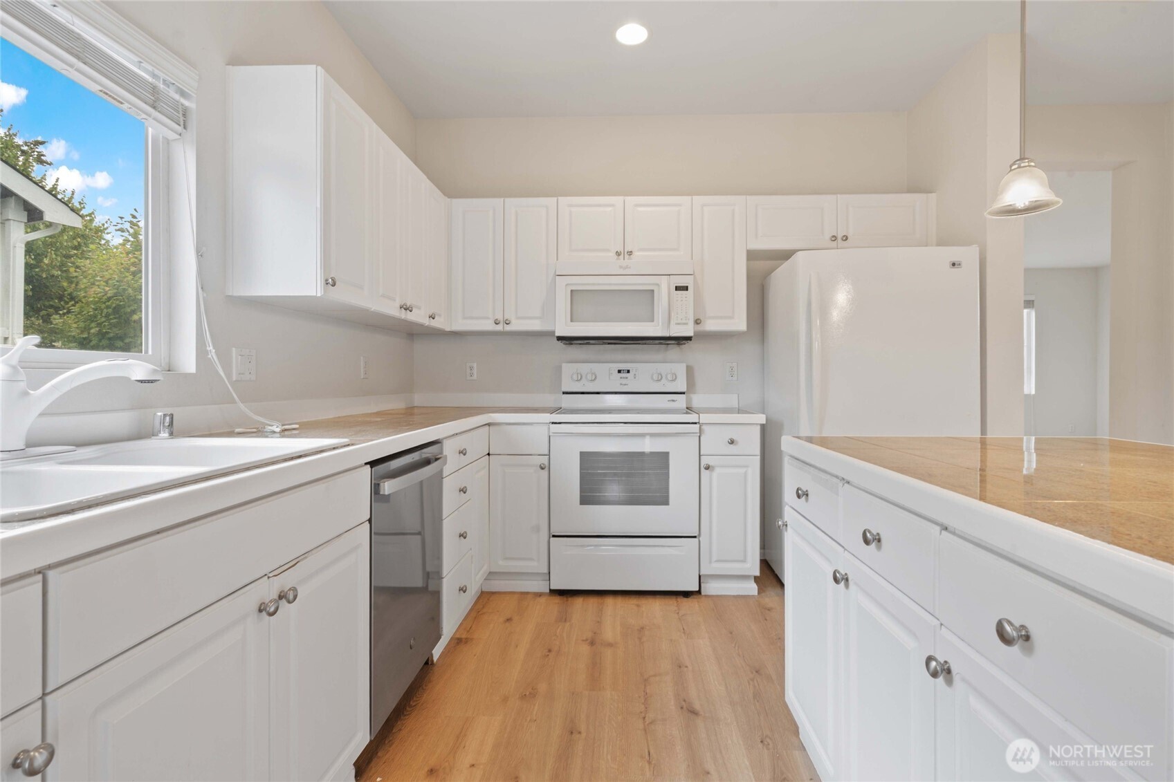 16919 165th Place Southeast Renton, WA 98058 - Photo 13 of 29 a kitchen with white cabinets appliances and a sink