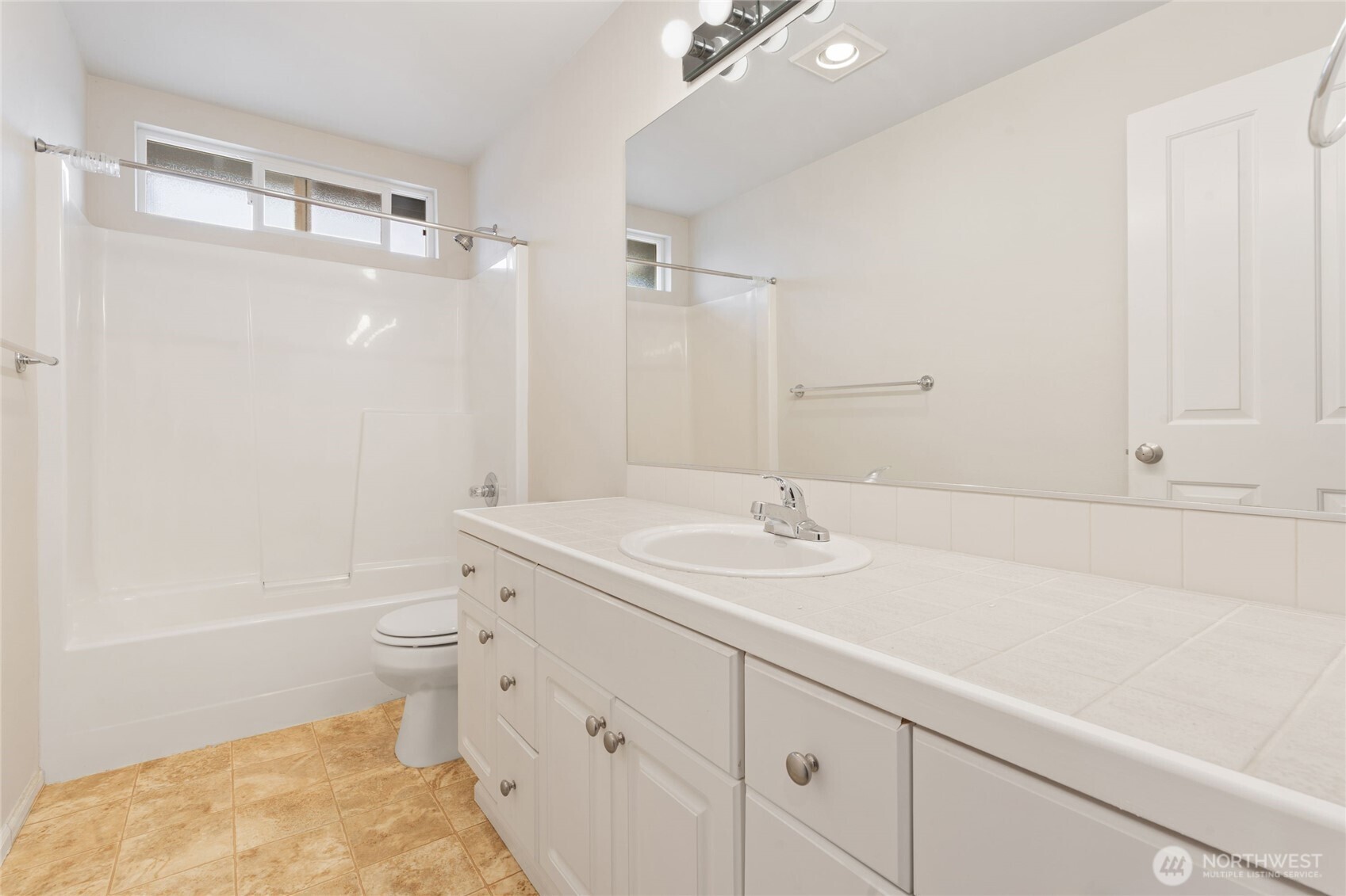 16919 165th Place Southeast Renton, WA 98058 - Photo 23 of 29 a bathroom with a sink a toilet and shower