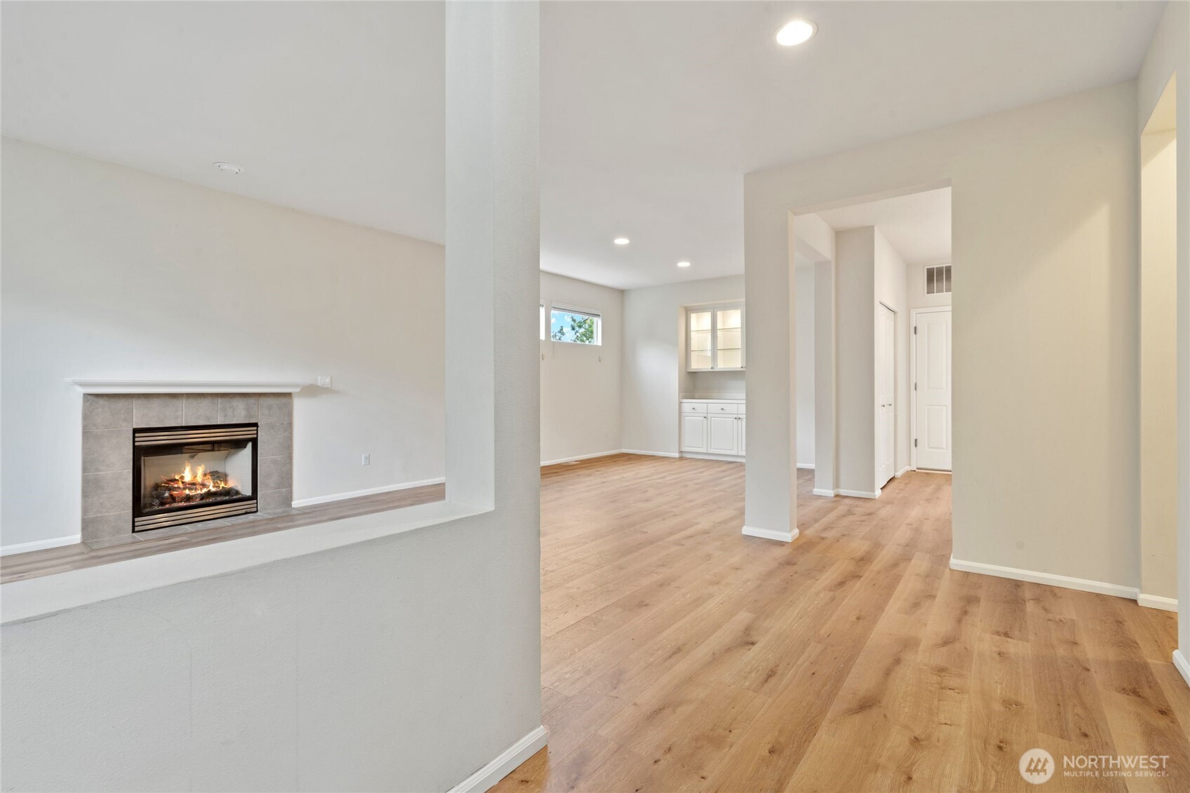 16919 165th Place Southeast Renton, WA 98058 - Photo 4 of 29 a view of an empty room and a cabinet with wooden floor