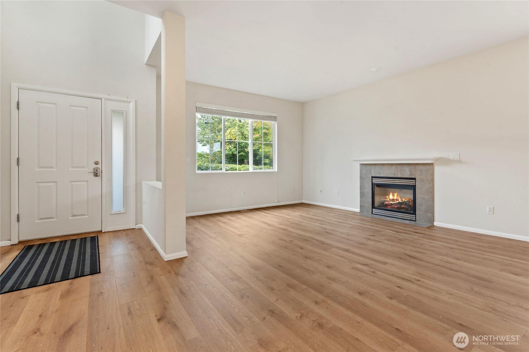 16919 165th Place Southeast Renton, WA 98058 - Photo 5 of 29 an empty room with wooden floor and windows