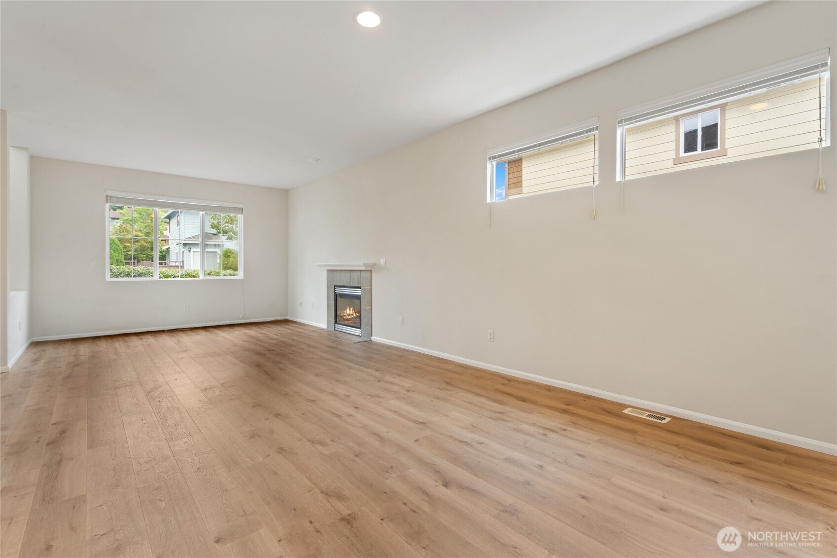 16919 165th Place Southeast Renton, WA 98058 - Photo 8 of 29 a view of empty room with wooden floor and fan
