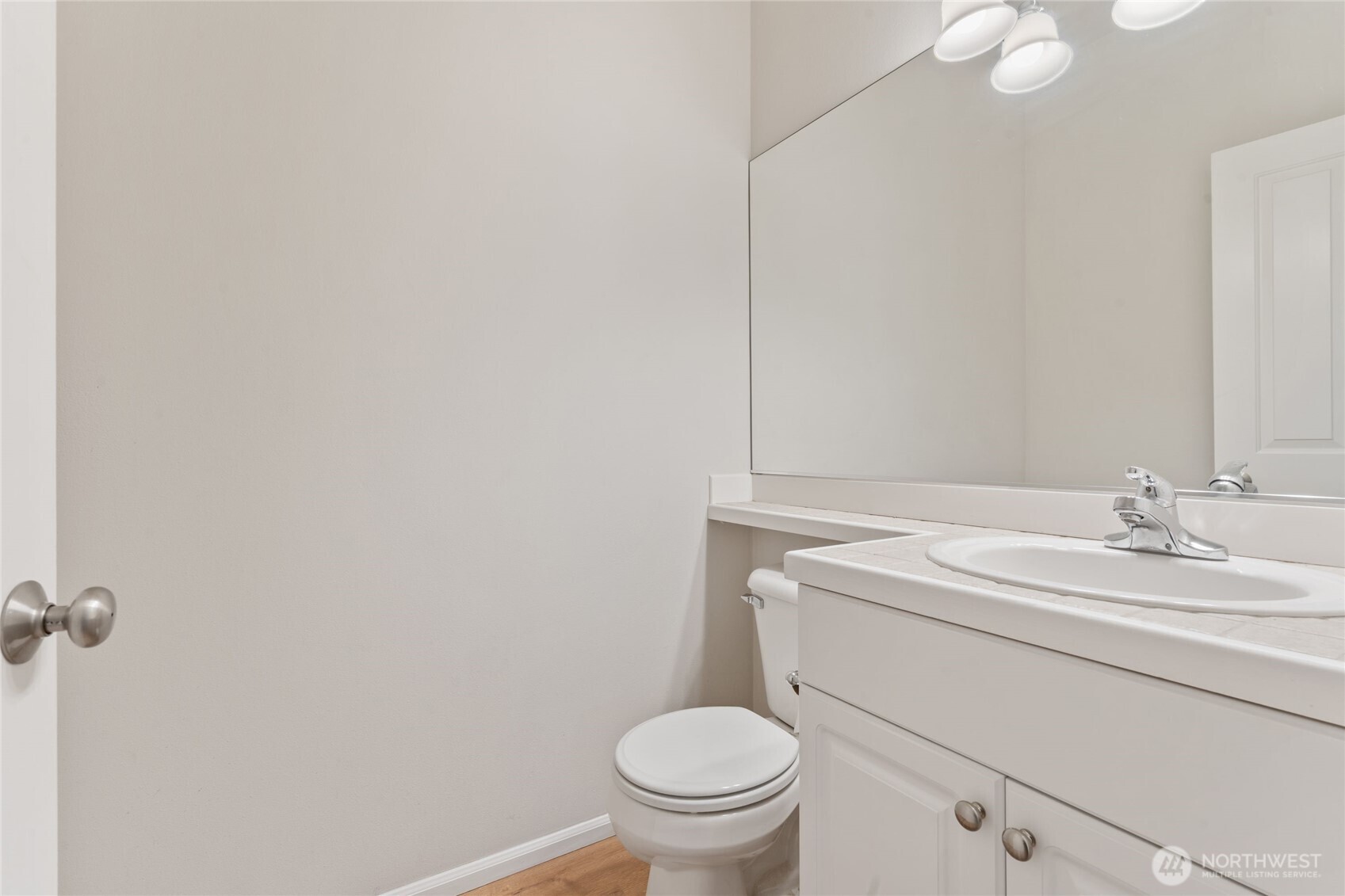 16919 165th Place Southeast Renton, WA 98058 - Photo 9 of 29 a bathroom with a toilet a sink and mirror