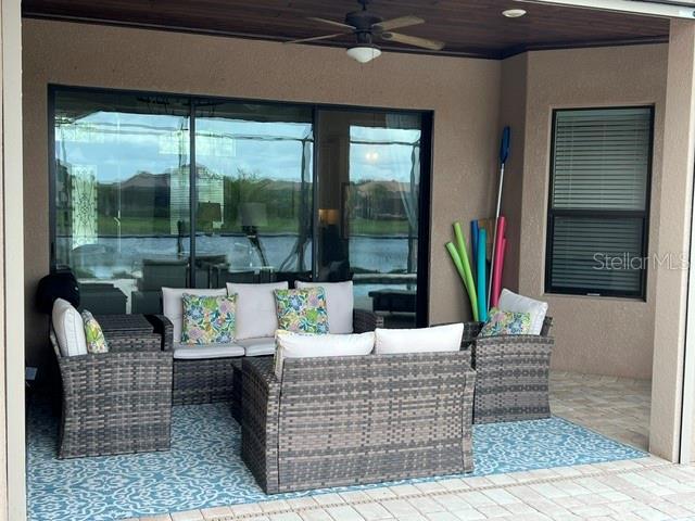5528 Arnie Loop Lakewood Ranch, FL 34211 - Photo 19 of 59 a outdoor living space with furniture and a potted plant