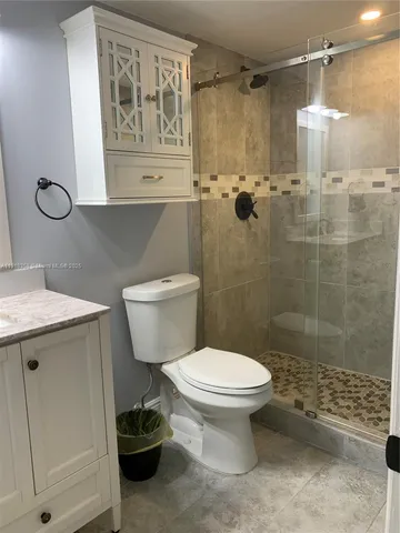 a bathroom with a toilet sink and shower