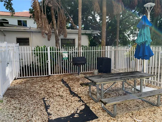 a view of a house with a wooden fence