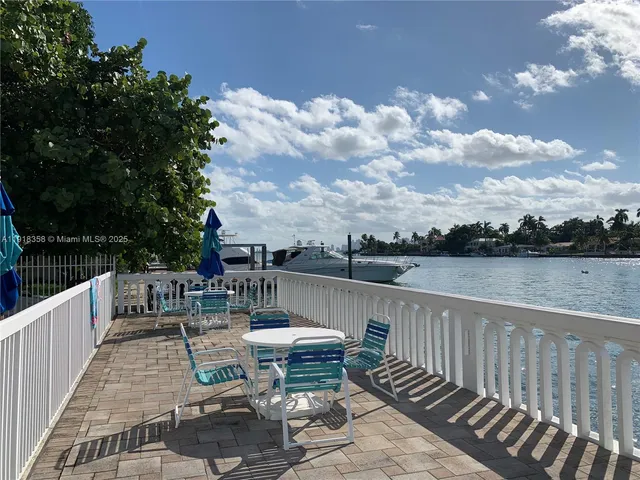 a balcony with wooden floor and lake view