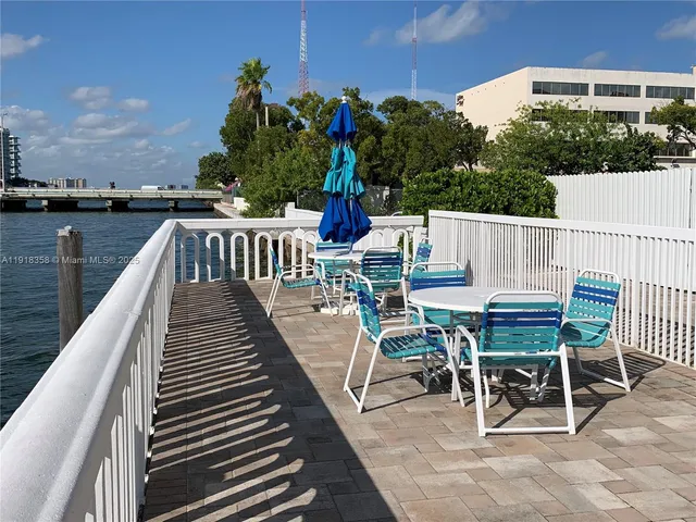 a living room with furniture and potted plants