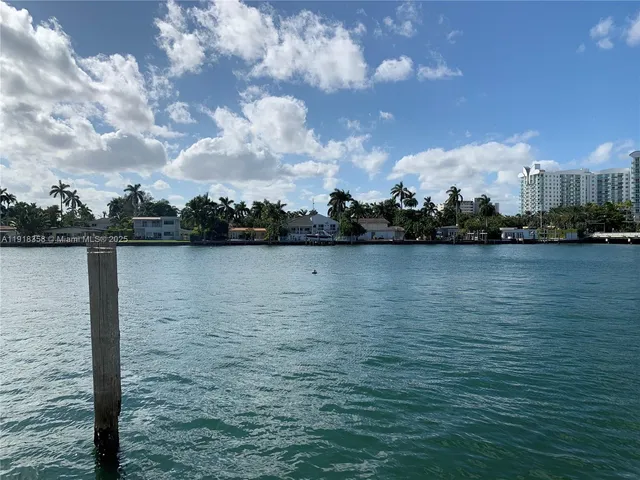 a view of a lake with houses in the back