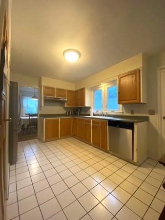 219 Clark Street Gardner, MA 01440 - Photo 11 of 29 a kitchen with stainless steel appliances kitchen island granite countertop a sink counter space cabinets and stainless steel appliances