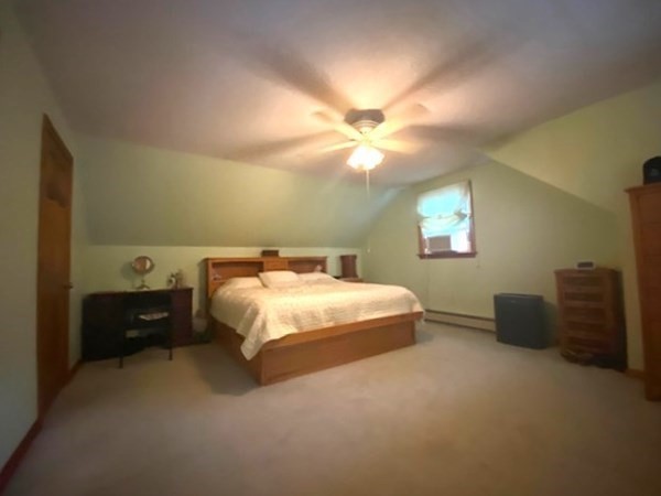 219 Clark Street Gardner, MA 01440 - Photo 23 of 29 a spacious bedroom with a bed and a chandelier