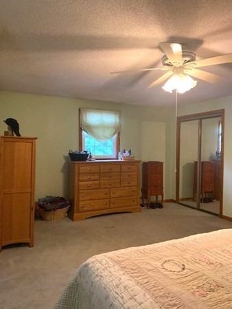 219 Clark Street Gardner, MA 01440 - Photo 24 of 29 a bedroom with a bed and a chandelier