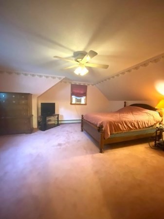 219 Clark Street Gardner, MA 01440 - Photo 26 of 29 a spacious bedroom with a bed and a chandelier