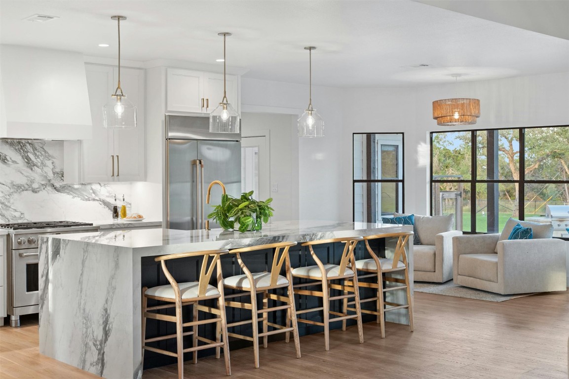 333 Stallion Lane Dripping Springs, TX 78620 - Photo 10 of 40 a dining room with furniture a chandelier and wooden floor