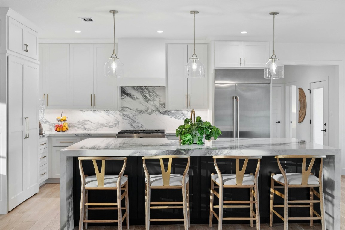 333 Stallion Lane Dripping Springs, TX 78620 - Photo 11 of 40 a kitchen with granite countertop kitchen island and stainless steel appliances