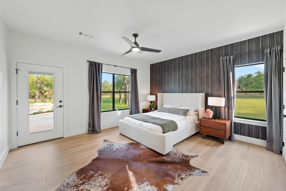 333 Stallion Lane Dripping Springs, TX 78620 - Photo 18 of 40 a spacious bedroom with a large bed and a window