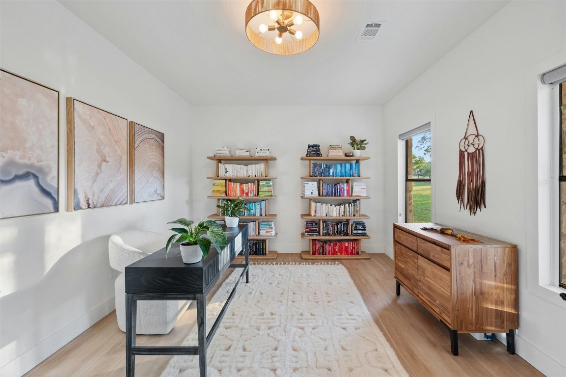 333 Stallion Lane Dripping Springs, TX 78620 - Photo 21 of 40 a living room with furniture and a book shelf