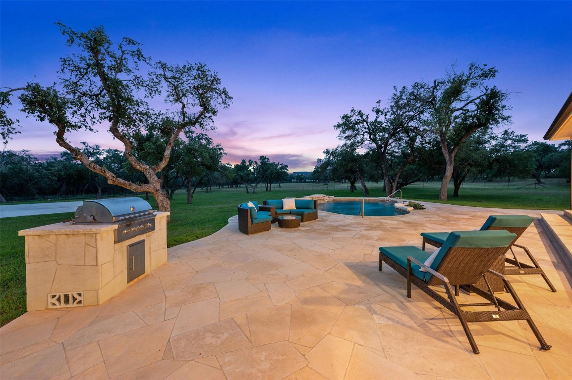 333 Stallion Lane Dripping Springs, TX 78620 - Photo 38 of 40 a view of backyard with swimming pool and outdoor seating