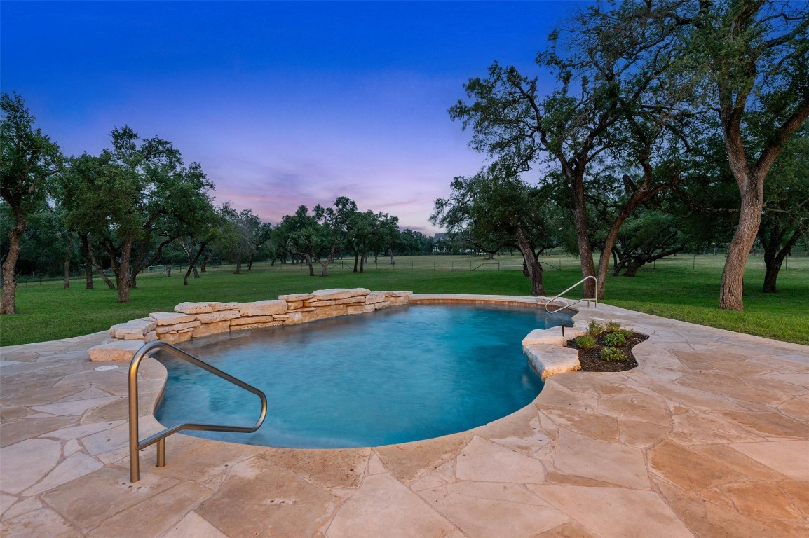 333 Stallion Lane Dripping Springs, TX 78620 - Photo 39 of 40 a view of a swimming pool and a yard