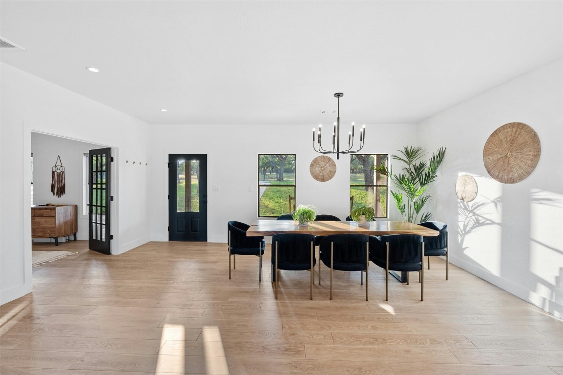 333 Stallion Lane Dripping Springs, TX 78620 - Photo 6 of 40 a view of a dining room with furniture window and wooden floor