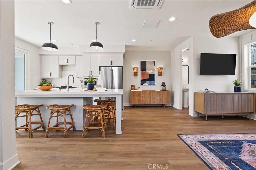 19071 Main Street, Unit 105 Huntington Beach, CA 92648 - Photo 4 of 18 a living room with furniture and a flat screen tv