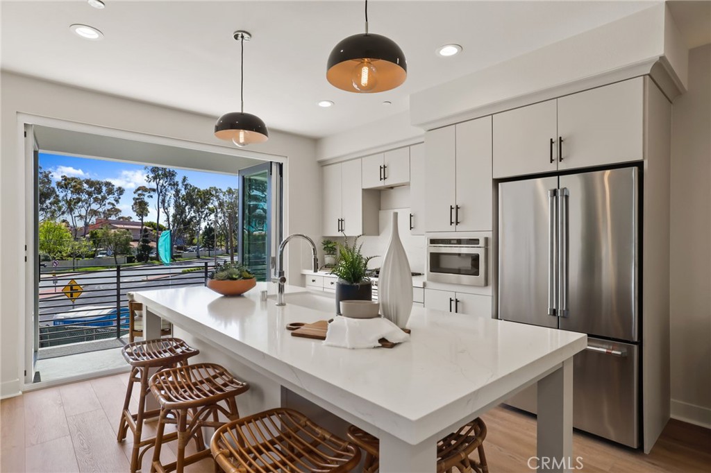 19071 Main Street, Unit 105 Huntington Beach, CA 92648 - Photo 7 of 18 a large kitchen with a table and chairs