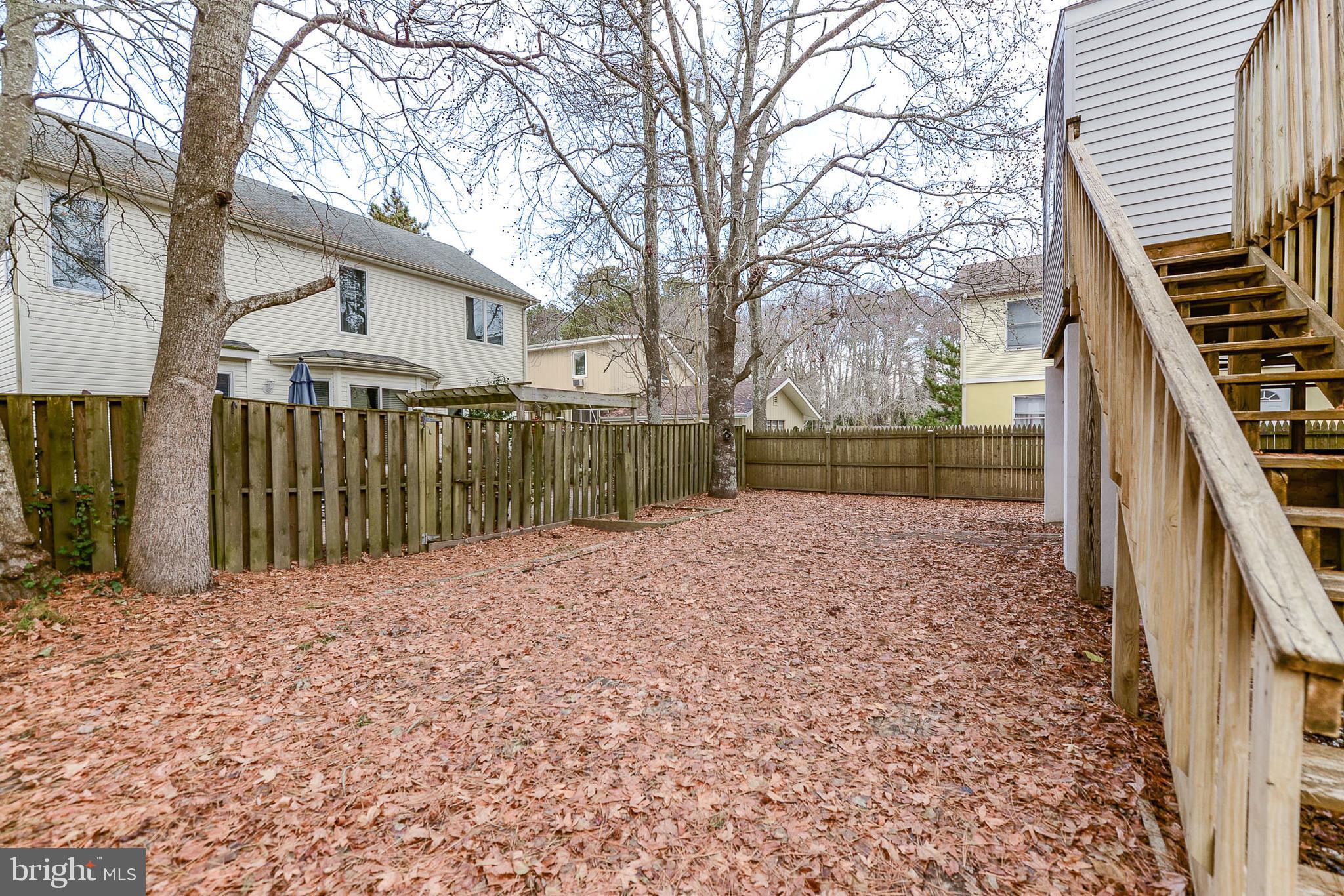 14013 North Ocean Road Ocean City, MD 21842 - Photo 5 of 35 REAR YARD: neighbors fencing