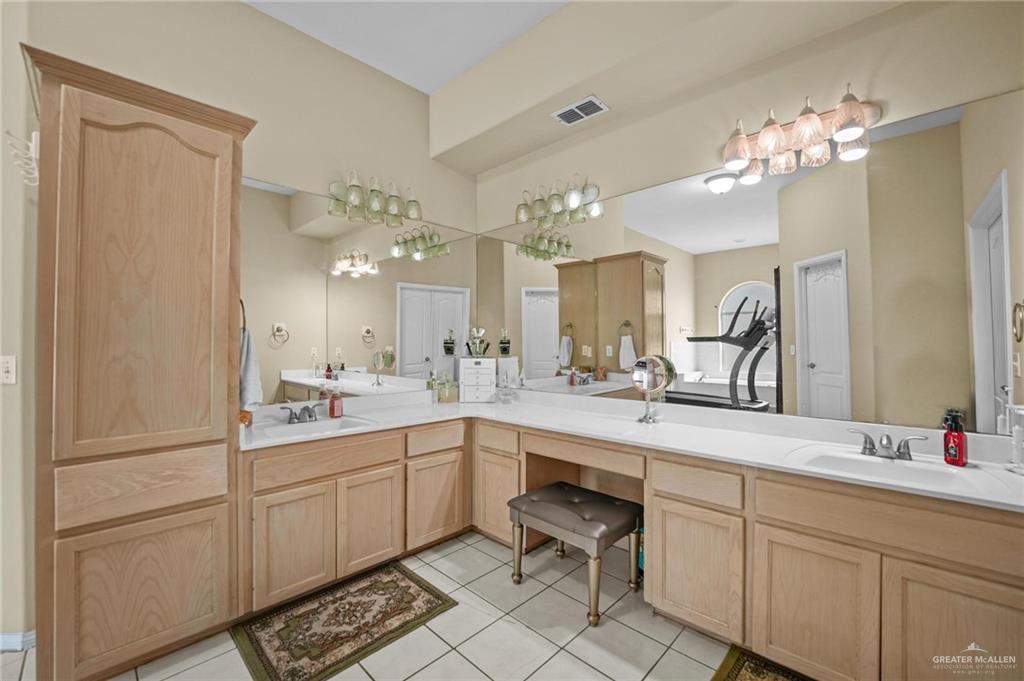 2809 Santa Laura Street Mission, TX 78572 - Photo 16 of 41 a spacious bathroom with a sink a large mirror and a shower