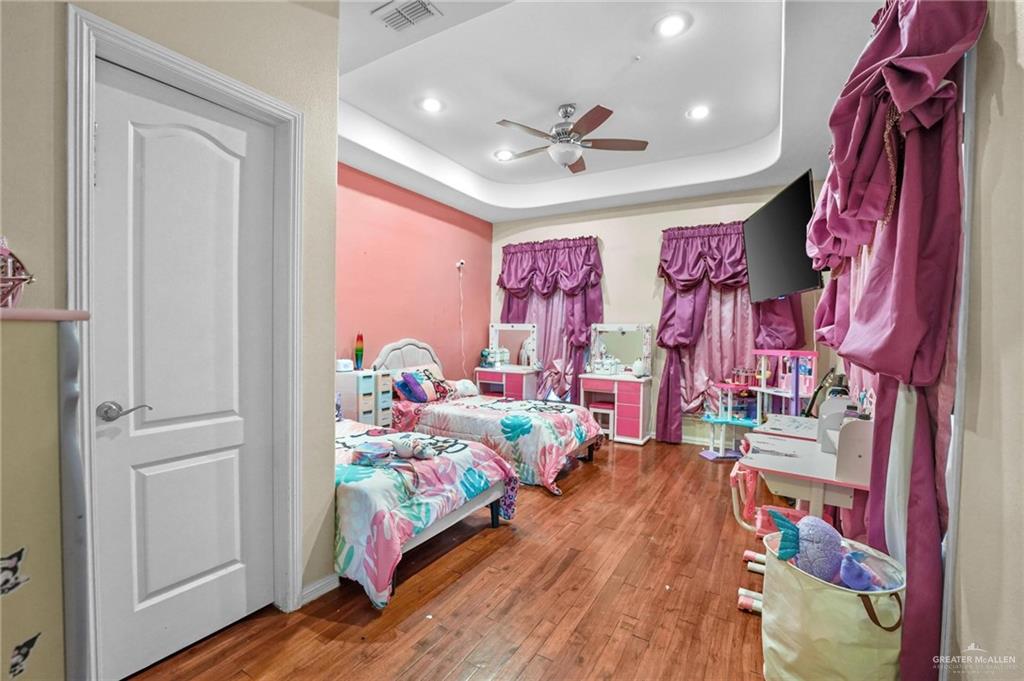 2809 Santa Laura Street Mission, TX 78572 - Photo 17 of 41 a bed room with a bed and a chandelier
