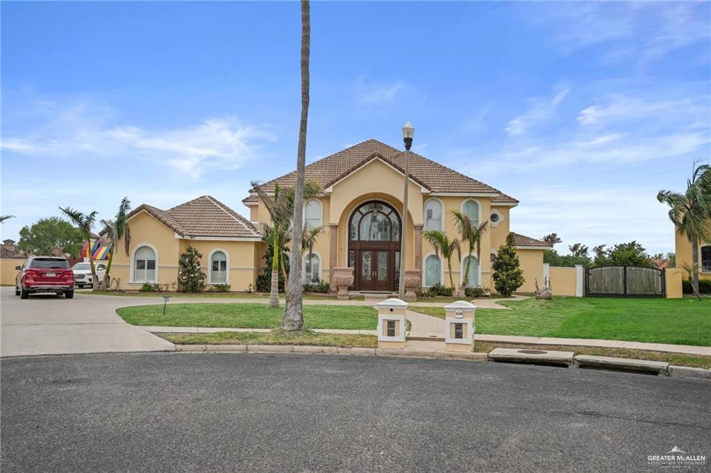 2809 Santa Laura Street Mission, TX 78572 - Photo 2 of 41 a front view of a house with a garden and trees