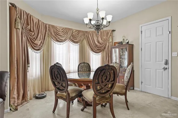 a view of a dining room with furniture and chandelier