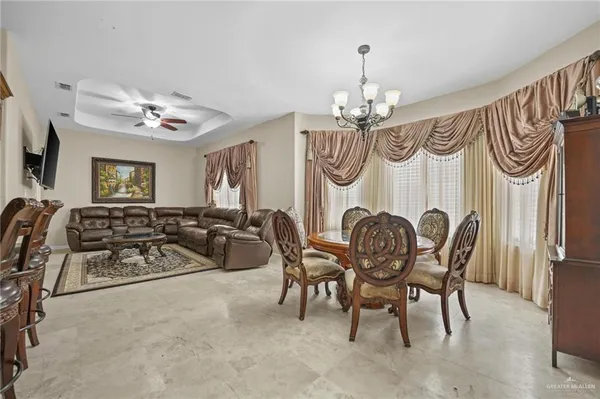 a view of a dining room and hall with furniture