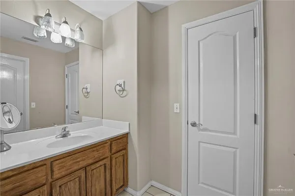 a bathroom with a double vanity sink and a mirror