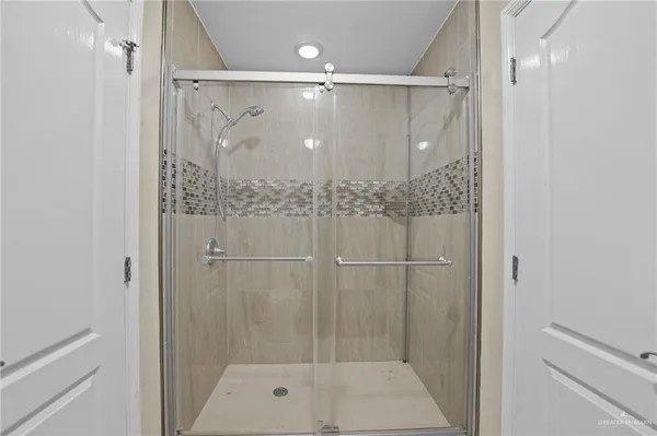 a bathroom with a glass shower door
