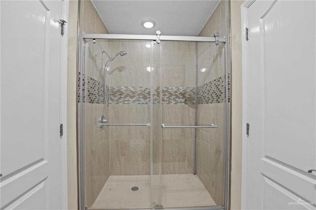 2809 Santa Laura Street Mission, TX 78572 - Photo 26 of 41 a bathroom with a glass shower door