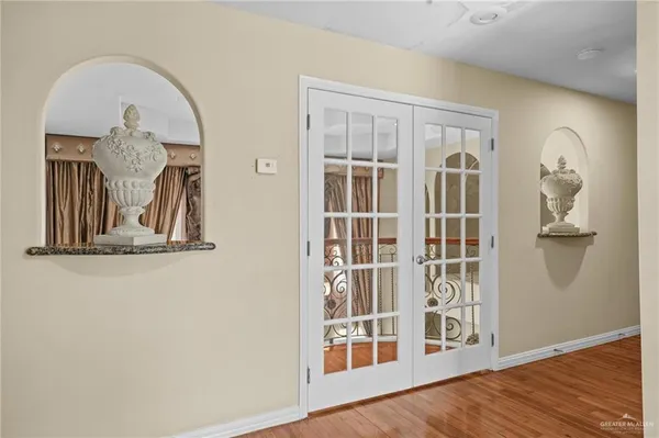 a view of a livingroom with wooden floor and a large window