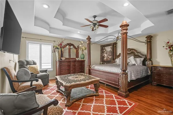 a living room with furniture a rug and a flat screen tv