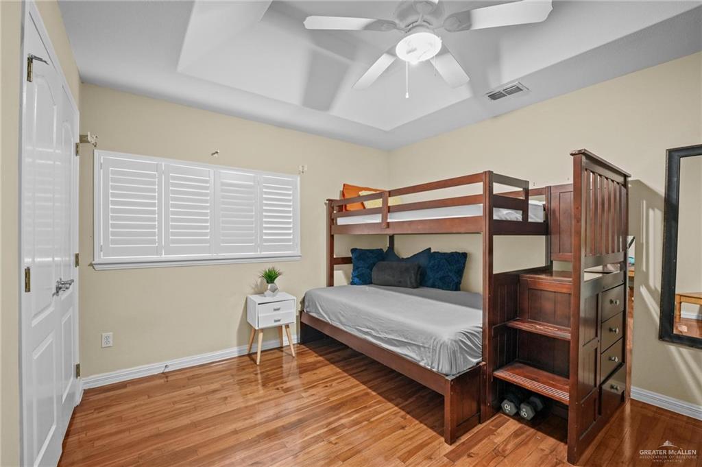 2809 Santa Laura Street Mission, TX 78572 - Photo 31 of 41 a bedroom with a bed and a chandelier