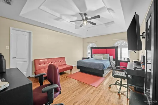 a bedroom with furniture and a flat screen tv