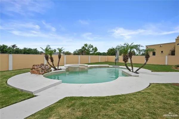an aerial view of a house with a yard and lake view