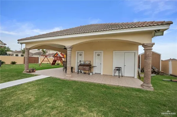 a view of a house with backyard porch and sitting area