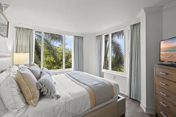 a bed sitting in a bedroom next to a window