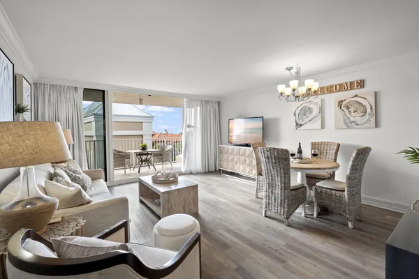 a living room with furniture and a chandelier