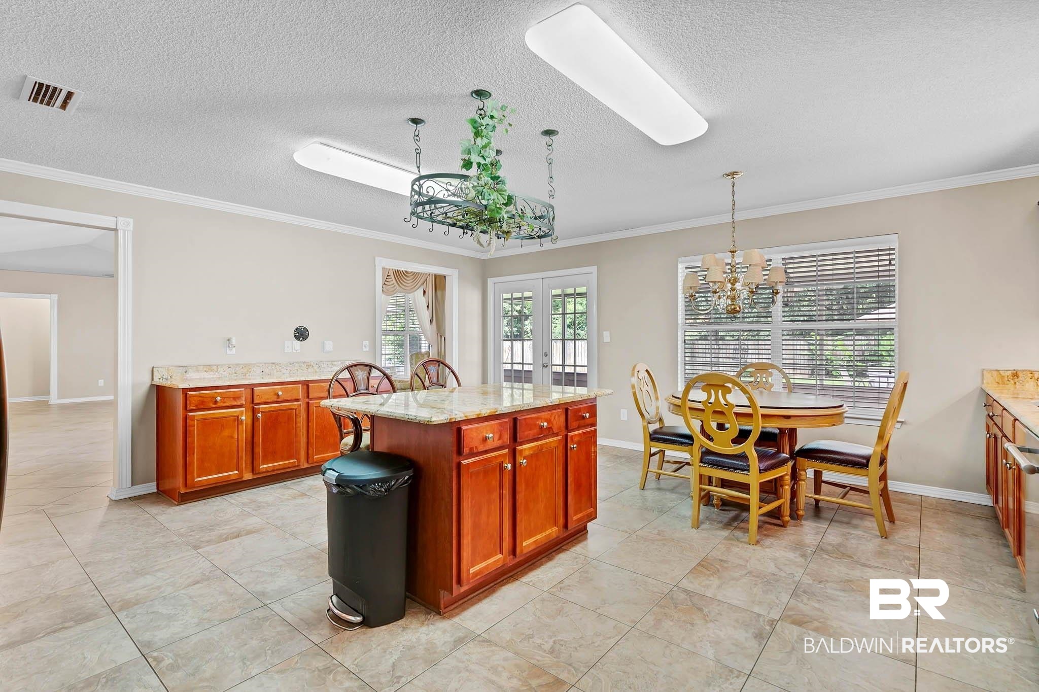 329 Collinwood Loop Foley, AL 36535 - Photo 11 of 35 Kitchen with french doors, crown molding, a chandelier, light stone countertops, and baseboards