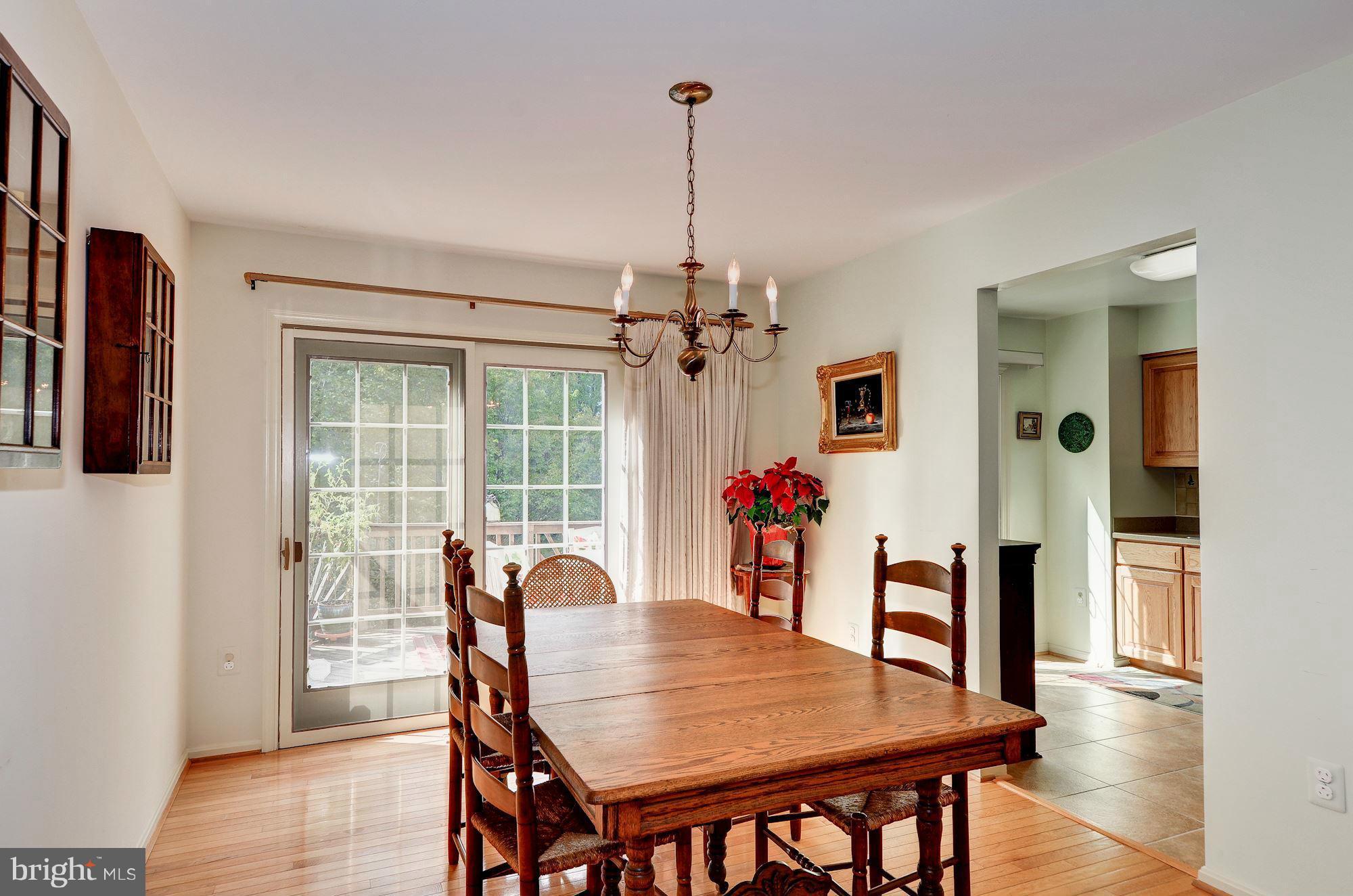 1946 Flowering Tree Terrace Silver Spring, MD 20902 - Photo 8 of 30 Dining Room with Sliding Glass Doors to Deck
