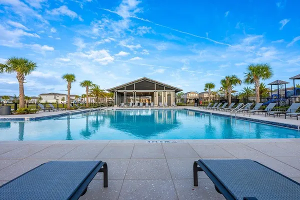 a view of a swimming pool with a lounge chairs