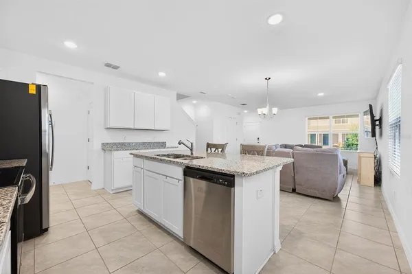 a kitchen with a sink window and refrigerator