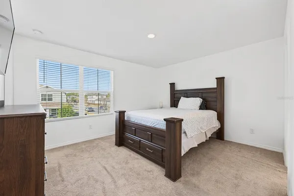 a bedroom with a bed and chair
