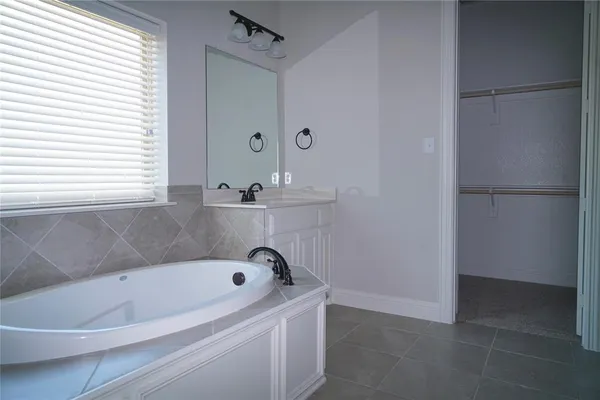a bathroom with a bathtub and shower