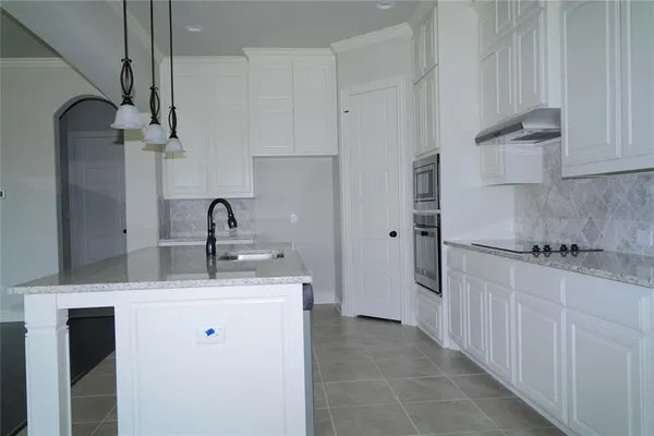 a kitchen with stainless steel appliances a sink stove and refrigerator