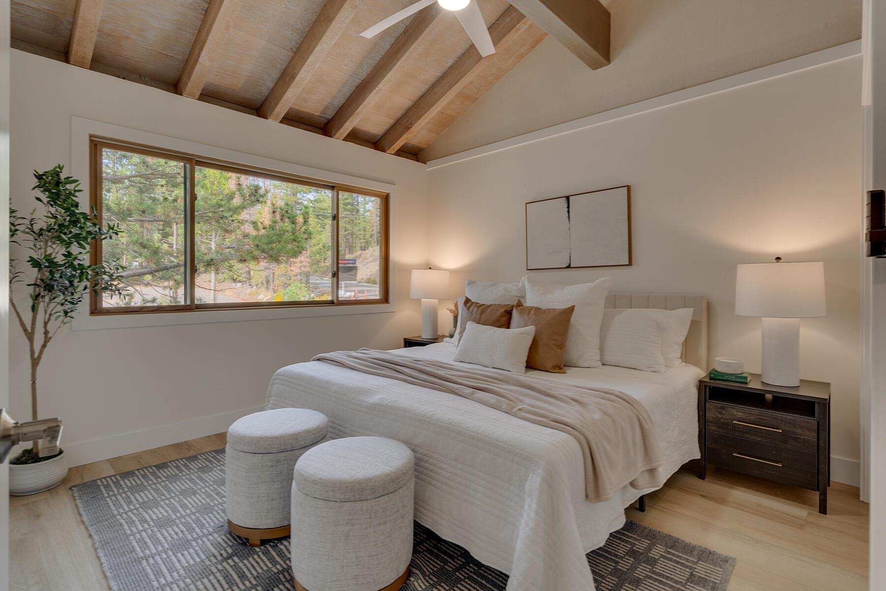 205 Alpine Meadows Road, Unit 2 Alpine Meadows, CA 96145 - Photo 13 of 28 a bedroom with a bed and a large window with outer view